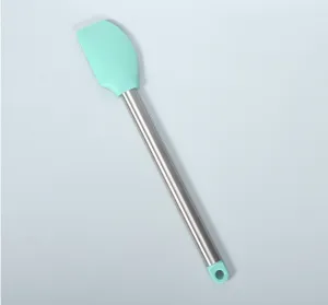 Silicone spatula detail close-up, stainless steel tube handle, essential baking pastry tool.