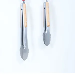 Stainless steel food tongs detail shot featuring durable metal and ergonomic wooden handles.