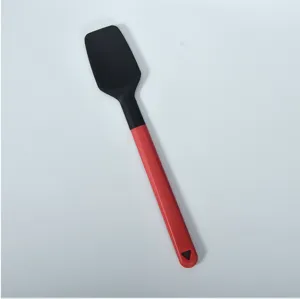 Silicone spatula detail showing the black head, red handle, and convenient hanging hole design.