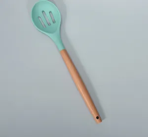 Silicone slotted spoon with solid wood handle, heat resistant cooking kitchen tool detail view.