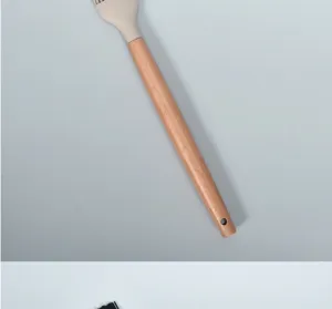 Silicone basting brush handle detail showing wood grain and heat-resistant silicone head.
