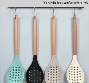 Silicone colander with solid wood handle, heat-resistant kitchen cooking tool detail view.