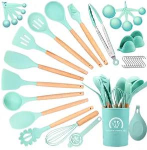 Mint green silicone kitchen utensils set with wooden handles, heat resistant cookware tools.