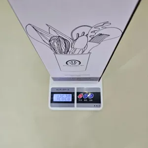 Silicone kitchen utensils set packaging box displayed on digital scale for weight details