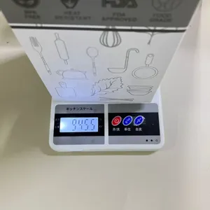 Detail view of digital kitchen scale showing weight measurement for kitchenware set.