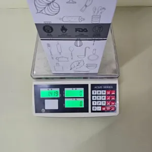 Detail view of 36pcs heat-resistant silicone kitchen utensil set packaging and weight check.