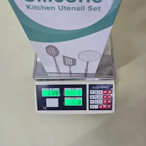 Detailed view of the silicone kitchen utensil set package being weighed on an electronic scale.