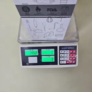 Detail view of silicone kitchenware set packaging being weighed, showing product compliance.