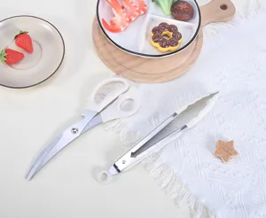 Detailed view of kitchen BBQ scissors and food tongs set, clean white handle design, durable steel.