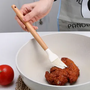 Silicone basting brush with solid wood handle for cooking, baking, BBQ, and kitchen use.
