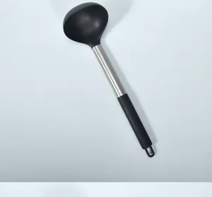 Close up view of stainless steel handle silicone soup ladle, heat resistant kitchen tool.