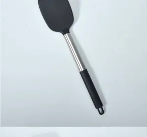 Detailed close-up of kitchen silicone spatula with stainless steel handle, heat resistant.