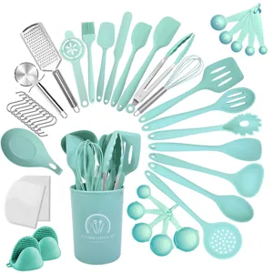 Detail view of mint green silicone kitchen utensil set with various spoons and a storage barrel.