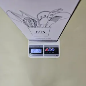 Silicone kitchen utensil set package box on digital scale, showing item weight clearly for buyers.
