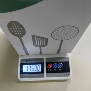 Silicone kitchen utensil set packaging on kitchen scale showing weight detail shot for cooking.