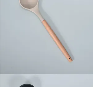 Silicone soup ladle with natural wooden handle, heat resistant nonstick kitchen cooking spoon detail.