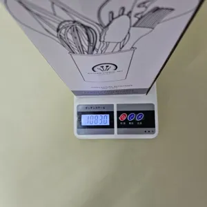 Detailed view of the silicone kitchen utensil set packaging on a digital scale showing weight.