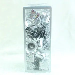 Detailed shot of silver Christmas tree ornaments set in a clear box for holiday decor.
