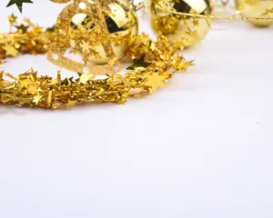 Christmas tinsel garland with golden stars and balls, perfect for holiday tree decoration.
