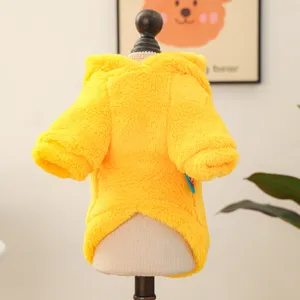 Detailed view of bright yellow plush pet hoodie, soft warm dog apparel on miniature mannequin.