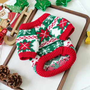 Christmas pet sweater detail shot, red and green knitted fabric with festive Nordic snowflake pattern.