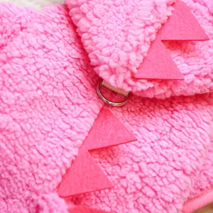 Pink plush pet dinosaur costume detail showing soft fleece fabric, spikes and D-ring.