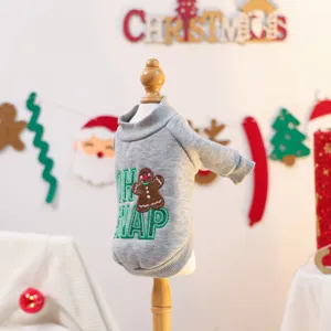 Close-up detail of grey pet sweater with cute gingerbread man embroidery for small dogs.