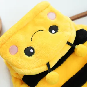 Cute plush pet costume detail shot, yellow and black winter warm puppy hoodie apparel.