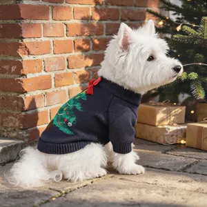 Detailed view of a cute dog wearing a festive Christmas knitted sweater with tree design.