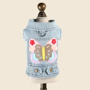 Detailed view of the pet denim jacket showing exquisite colorful butterfly embroidery and lapel.