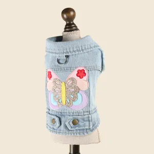 Detailed view of cute pet denim vest for dogs and cats with colorful butterfly embroidery.