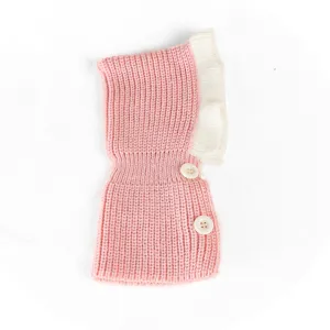 Cute pink knitted pet hat with white ruffles and buttons, perfect for small dogs and cats in winter.
