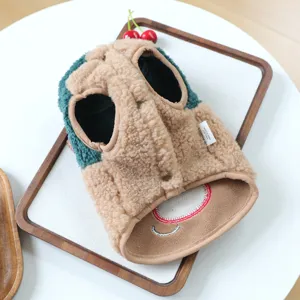 Detailed shot of cute winter pet fleece vest in brown and green, warm lamb wool.
