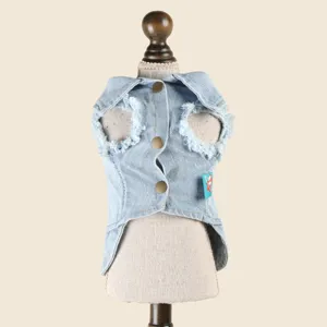 Detailed view of a stylish light blue pet denim vest featuring raw edges and metal snap buttons.