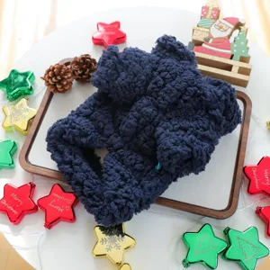 Detailed shot of dark blue plush pet winter warm clothes displayed with Christmas holiday props.