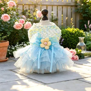 Cute dog tutu dress with multi-layer mesh tulle, large bowknot and flower in garden setting.