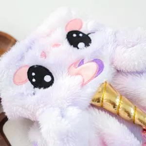 Fluffy plush pet costume detail view with cute embroidered eyes and golden unicorn horn.