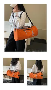Large capacity orange cylindrical gym duffel bag, waterproof travel sports shoulder bag.