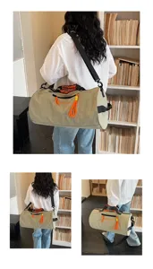 Large capacity cylindrical fitness travel bag with dry wet separation and orange accents.