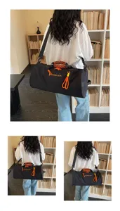 Large capacity cylindrical gym travel duffel bag with wet dry separation and orange handles.