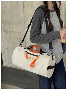 Large capacity cylindrical duffel fitness travel bag with waterproof design and orange details.