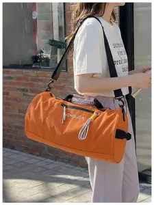 Large capacity cylindrical sports duffel bag, waterproof travel fitness bag with shoulder strap.