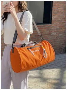Orange cylindrical waterproof fitness duffel bag, large capacity travel gym sports bag.