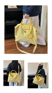 Large capacity canvas travel bag with top handle and shoulder strap, stylish embroidered design.