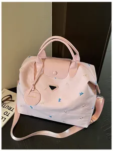 Pink nylon travel duffel bag with embroidered bows, large capacity gym tote for women.