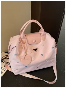 Pink large capacity travel duffel bag with cute bow embroidery for women daily commute.