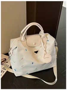 Detailed view of the large capacity travel duffel bag with cute embroidery and nylon.
