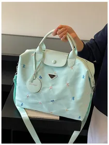 Large capacity travel duffel bag for women, stylish Korean style shoulder luggage handbag.