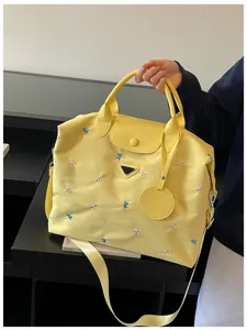 Yellow large capacity travel bag with cute bow embroidery, perfect for gym and commute.