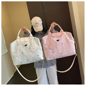 Korean style large capacity travel duffel bag with cute bow embroidery and shoulder strap.